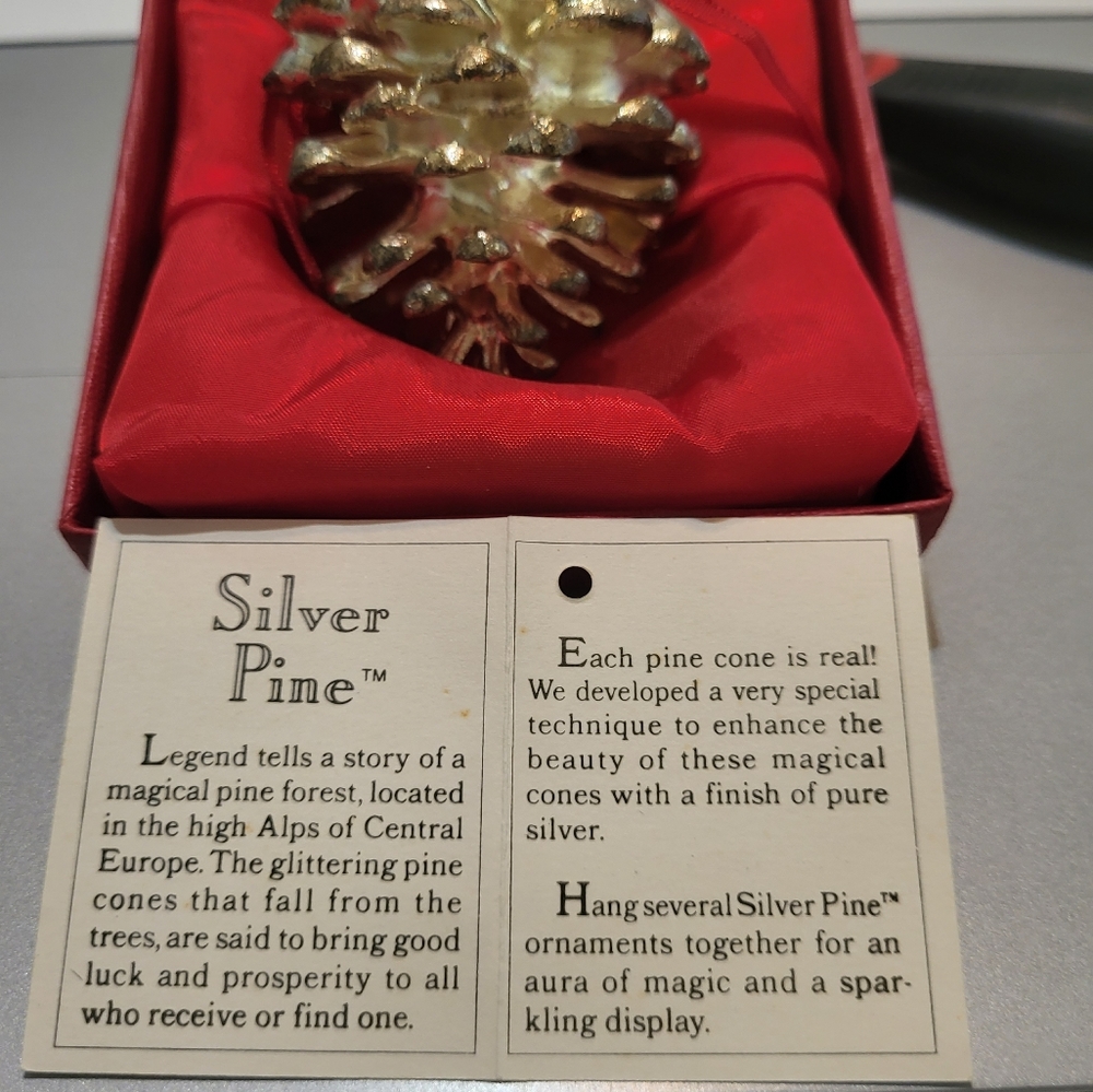 Christmas  tree ornament.  Real cone covered in special silver material.  3"tall